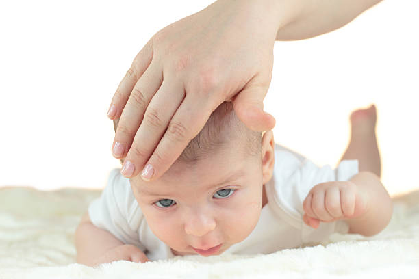 istock Cute little baby with mother hand isolated on white 166214721