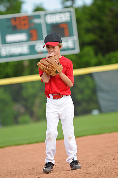 Nervous baseball pitcher Nervous little league baseball player. youth baseball and softball league photos stock pictures, royalty-free photos & images