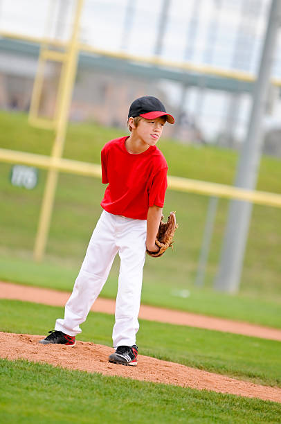 istock Youth baseball pitcher in red jersey 166214843