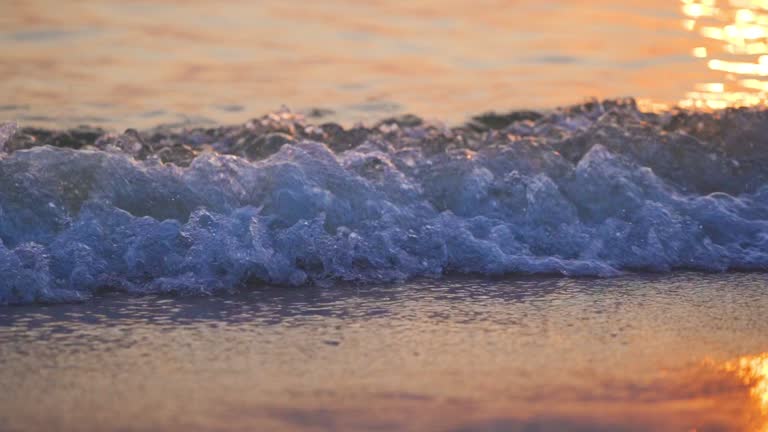 stunning beautiful reflection of golden sunlight at sundown time over the sea.