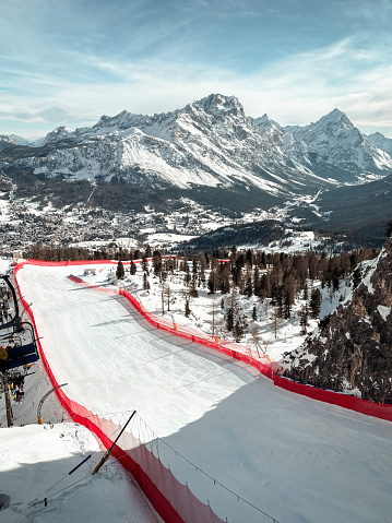Scenic view of Tofana ski racing slope in Cortina d'Ampezzo in Italy against snow covered Punta Sorapiss Mountain (middle) and Antelao (right)