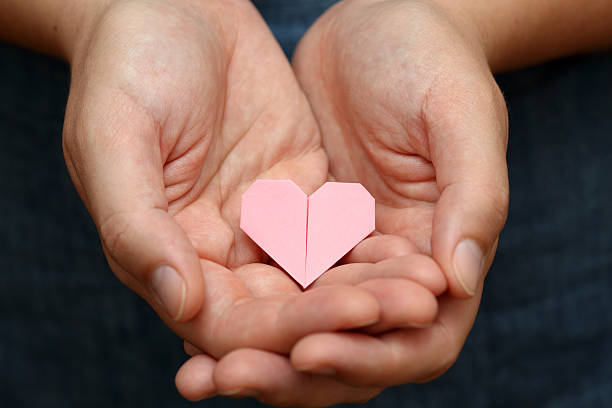 istock Origami heart in human hands. 166219185