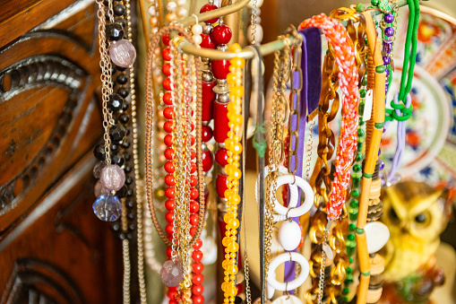 Strands of colorful beaded jewelry are hanging on retail display in downtown Ocala, Florida.