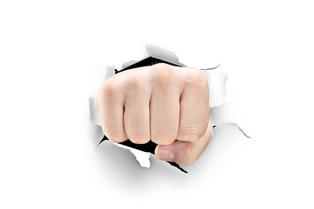 istock Male fist breaking through a white paper 166223688