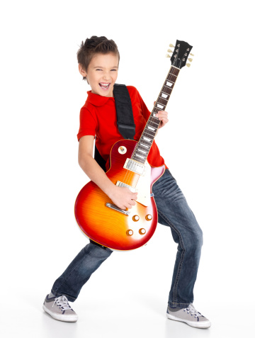 A young white boy sings and plays on the electric guitar with bright emotions, isolatade on white background