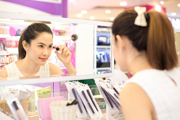 アジアの女性のショッピングには、化粧品を保管します。 - asian ethnicity women shopping mall perfume ストックフォトと画像