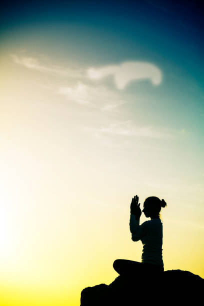 istock Female meditating on rock 166224319