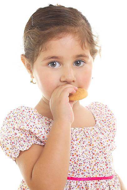 istock Little Girl Eating Cookie 166226146