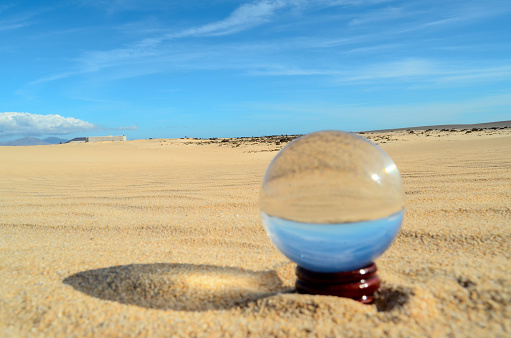 Conceptual Photo Picture of a Crystal Sphere in the dry desert