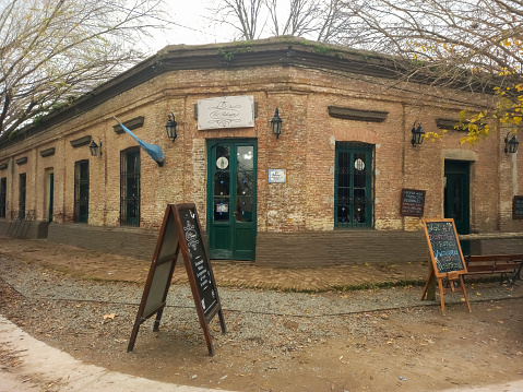 Uribelarrea, Argentina - Jul 15, 2023: The old brick facade of El Palenque , built in 1890, former pulperia and general store, nowadays cafe restaurant in the ancient rural town of Uribelarrea, Buenos Aires Province, Argentina.