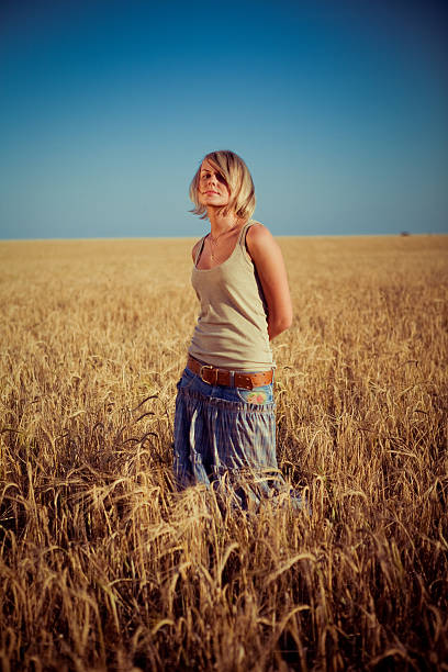 istock young woman on wheat field 166232096