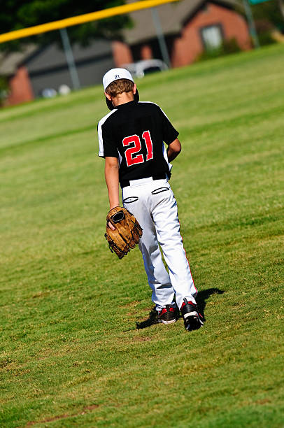 istock Youth baseball player walking on field 166232450