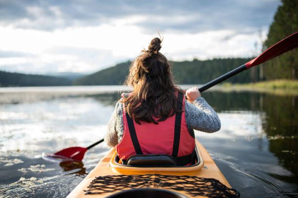 istock Young woman kayaking in a mountain lake. 1662335544