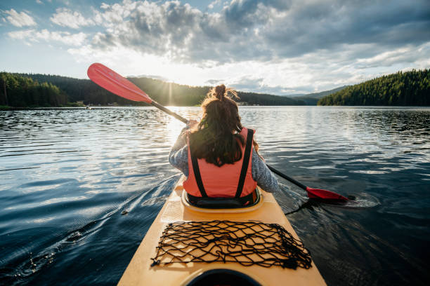 istock Rear view of woman kayaking. 1662335555