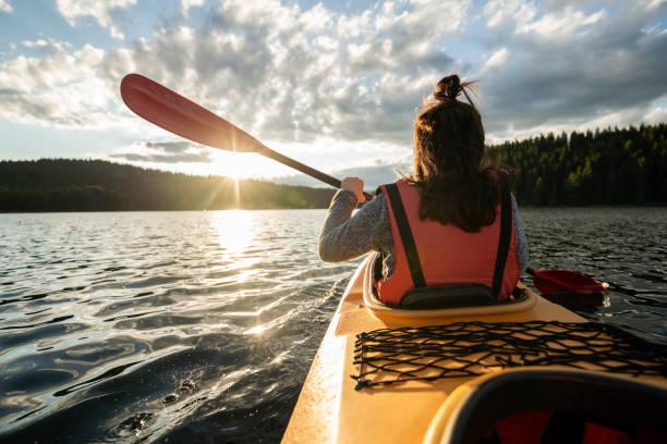 istock Rear view of woman kayaking. 1662335557