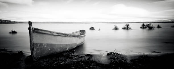 istock Fishing boat on lake beach 166234348