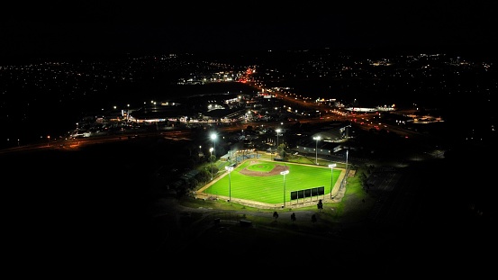 Aerial shot of a baseball field with its flood lights on