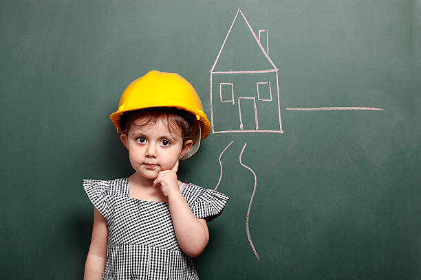 istock Little engineer with helmet in front of blackboard 166237363