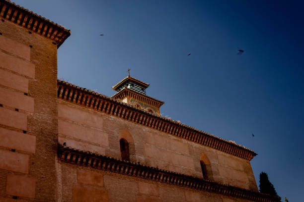 An ancient building against a blue sky on the streets of Grenada stock photo