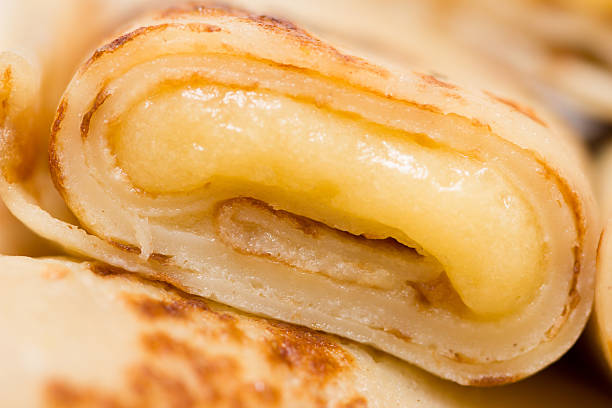 Macro of thin pancake filled with vanilla cream stock photo