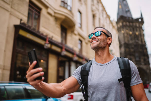 istock Attractive man with backpack holding smartphone during sightseeing tour. 1662434566