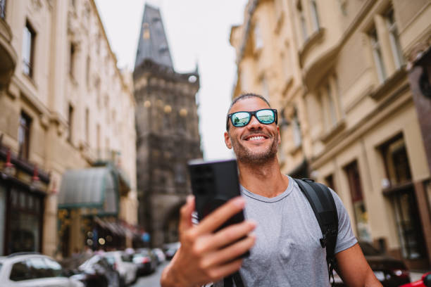 Man taking a selfie in front of historic monument.