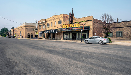 Conrad, Montana, USA – August 17, 2023:  Exterior of the Orpheum Theater and Olson’s Drug Store in the downtown district