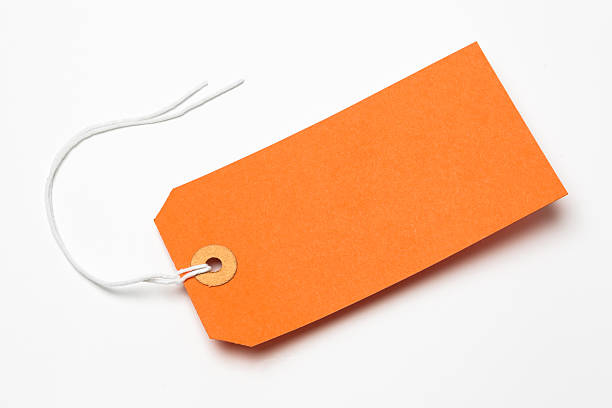 istock Orange cardboard or paper luggage tag isolated on white 166244403