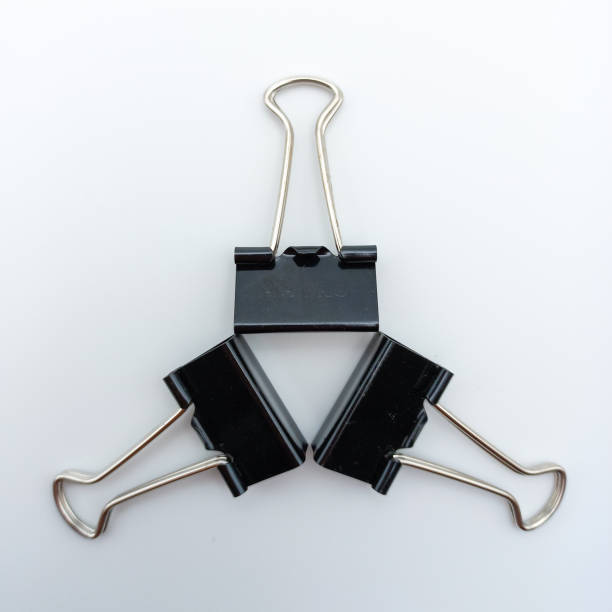 istock Three Binder Clips Arranged In Star Position Isolated On White Background 1662445145