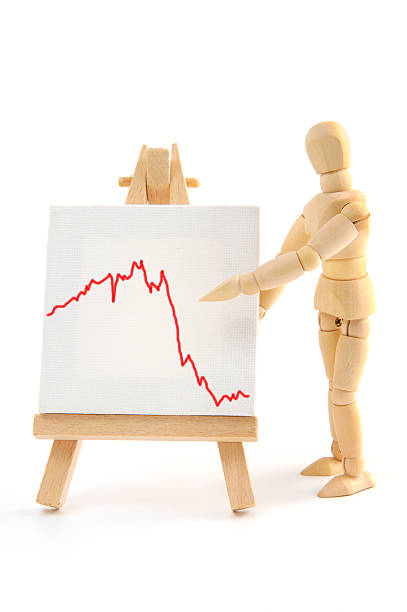 istock Wooden mannequin pointing with hand on business graph 166246248