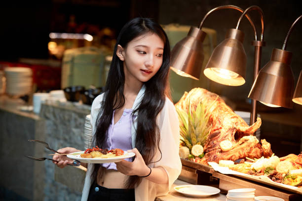 istock A girl eating at a buffet restaurant 1662498622