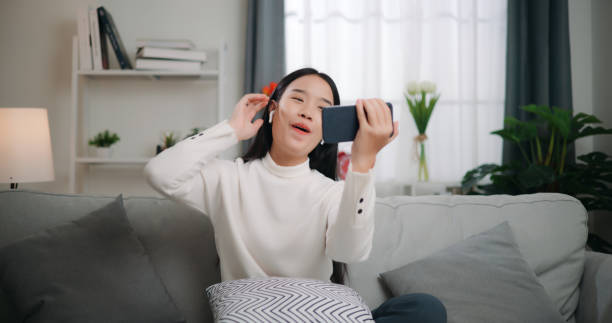 istock Asian woman playing a game on smartphone 1662503940