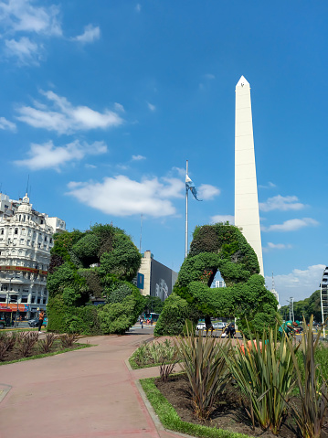 Buenos Aires, Argentina - Mar 29, 2023: BA initials and the Obelisk, modern symbol of the city of Buenos Aires, at the intersection of 9th July Ave. and Corrientes Ave. Built in 1936. Copyspace