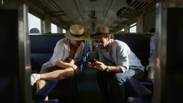 4K Caucasian man tourist travel in Thailand on local train.