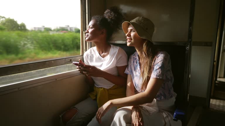 4K Group of Diversity people friends travel in Thailand on local train.