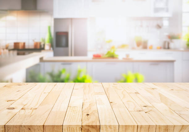 istock Selective focus.Wood table top on blur kitchen counter in morning background.For montage product display 1662586317