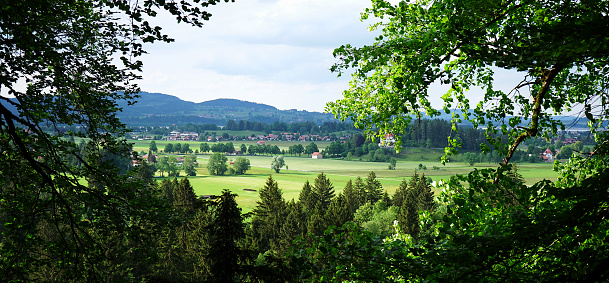 View towards Römerberg with its vineyards and a village, Markgräflerland. View towards Rhine on a cloudy day, Vogese mountains on horizon.