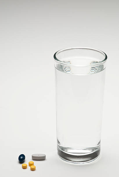 Glass with water and medicine.