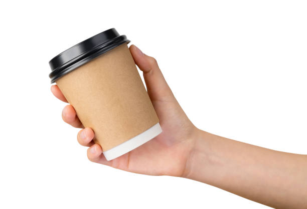 istock Clipping path, hand holds coffee paper cup on isolated white background. 1662589474