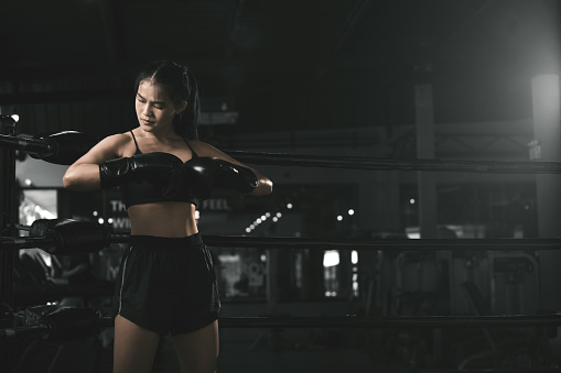 Young woman boxer training at the gym.