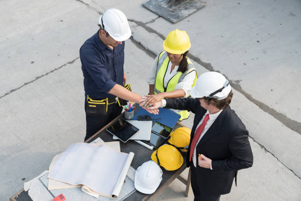 istock Group of foreman builder discussing and planning of precast concrete wall structure quality at construction site 1662669043