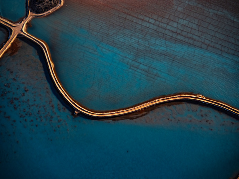 Aerial photo taken from a small plane showing a salt works and salt working Useless Loop, Shark Bay, Western Australia