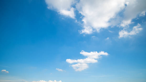 istock Panoramic view of clear blue sky and clouds, Blue sky background with tiny clouds. White fluffy clouds in the blue sky. Captivating stock photo featuring the mesmerizing beauty of the sky and clouds. 1662674503