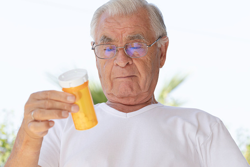 Senior man taking prescription medicine