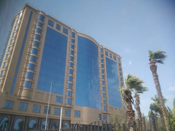 istock The blue building view in the city with palm tree 1662677645