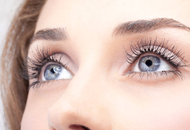 Close-up of woman's grey eyes with mascara stock photo