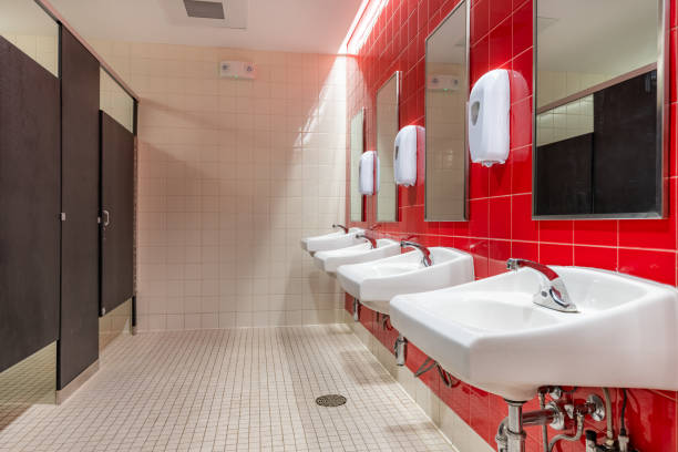istock Public restroom with red tile and four, lavatories, sinks 1662703866