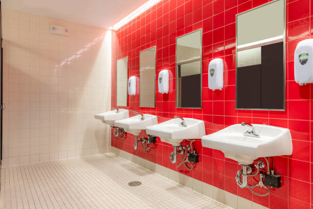 istock Public restroom with red tile and four, lavatories, sinks 1662703867