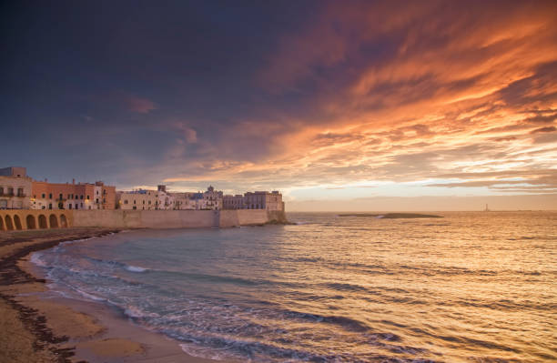 istock Waves washing up on coastal city walls 166272103
