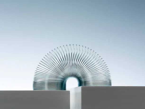 Photo of Metal slinky spanning space between blocks